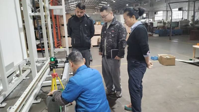 Maintenance engineer replacing vulnerable wear parts on a commercial carpet tufting machine